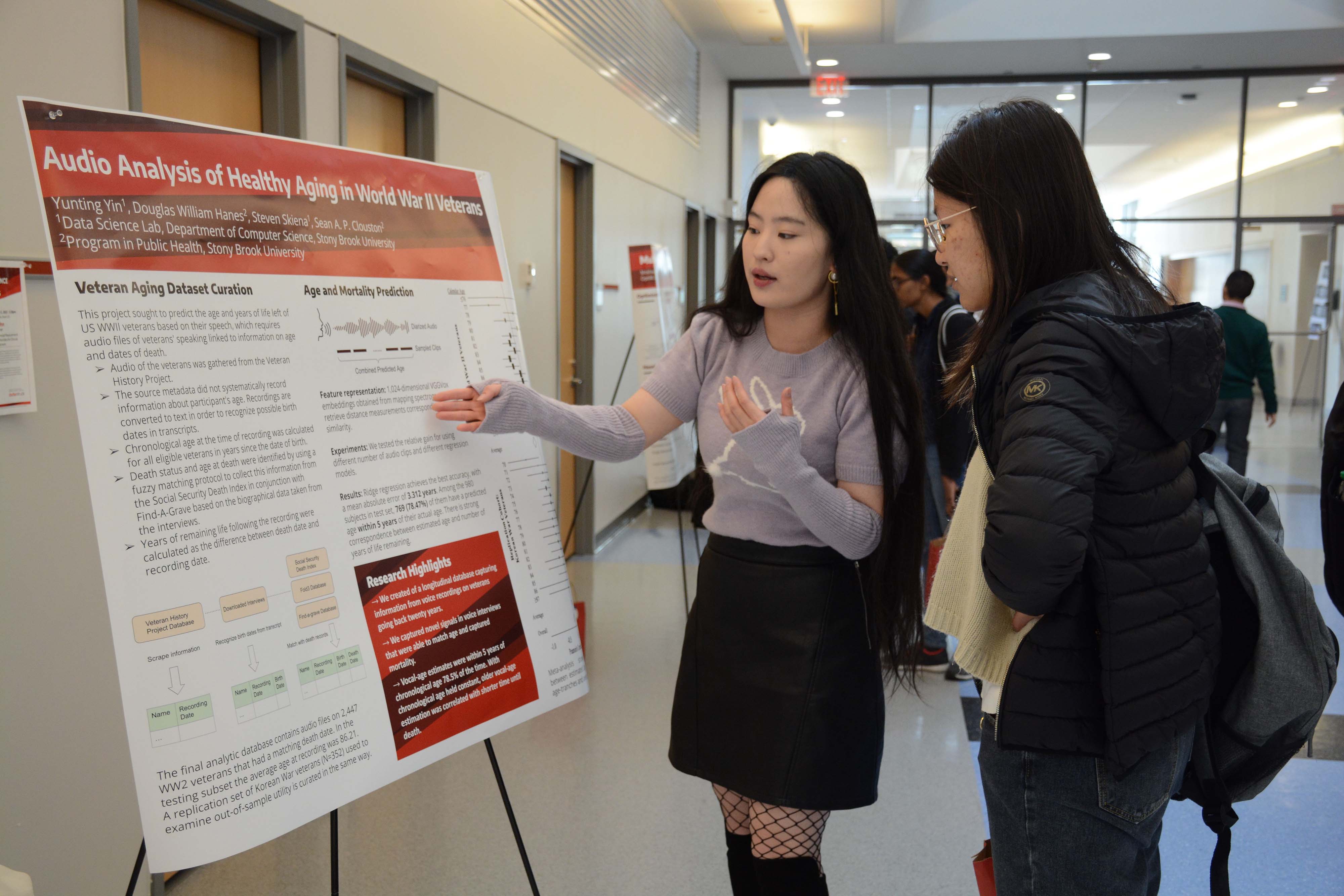 Graduate students presenting computer science research projects on posters at the New Computer Science Building