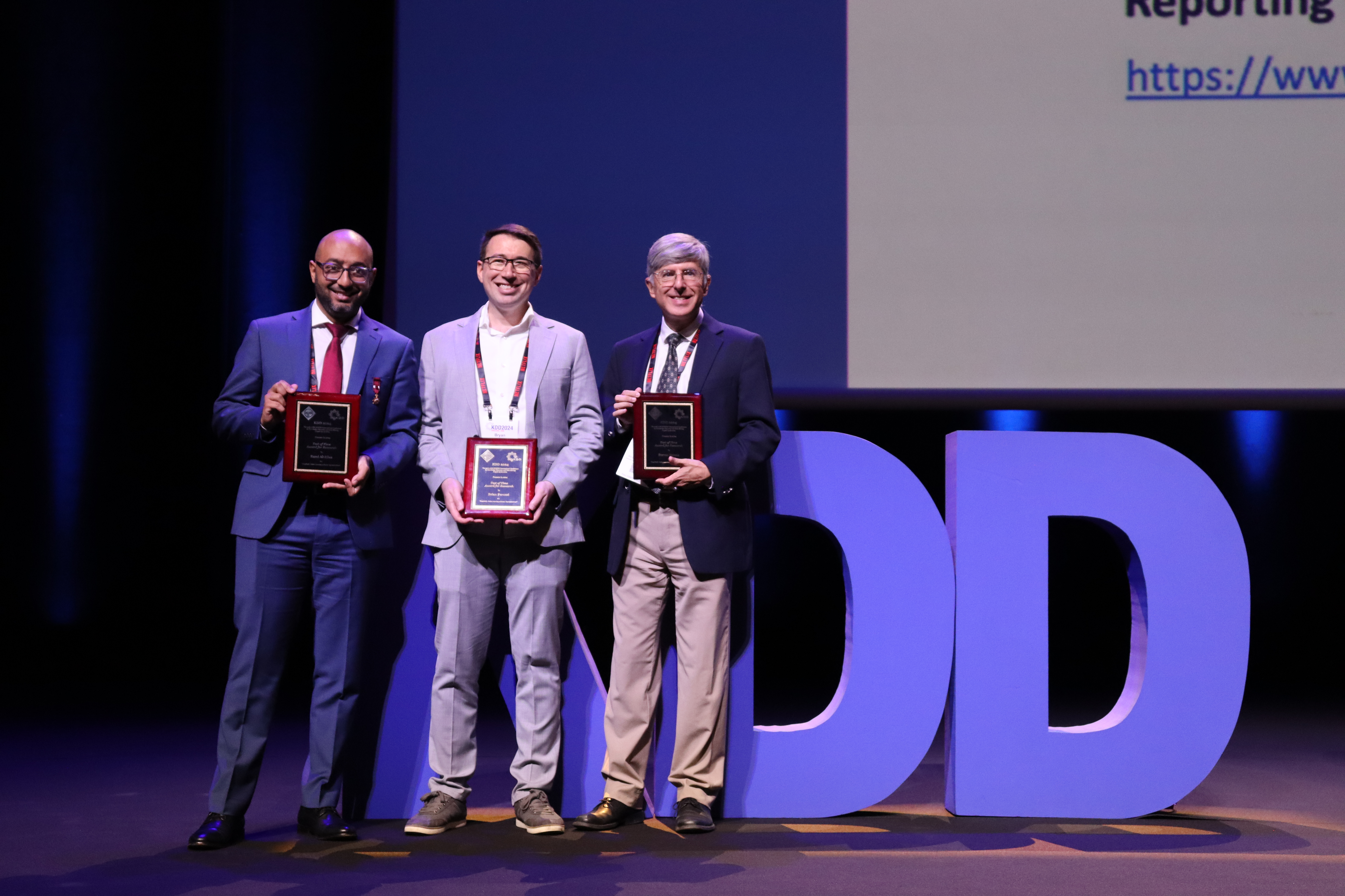 Left to right: Researchers Rami al-Rfou, Bryan Perozzi, and Steven Skiena pose with their awards at the KDD Conference in Barcelona, Spain.