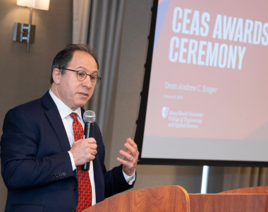 Dean Andrew Singer addresses attendees at the awards ceremony.