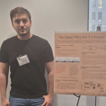 Chris Tsoukaladelis poses next to the winning poster